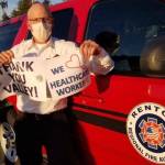 Fire Chief Rick Marshall holds signs of support during an April first responders Thank You parade for Valley Medical staff. Photo courtesy of RRFA.