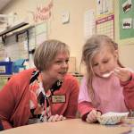 Long time board member Pam Teal with a child at Meadow Crest Early Learning Center, 2018. Courtesy photo.