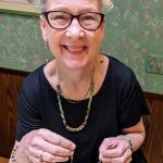 Liz Falconer smiling as she crafts jewelry (photo credit: Liz Falconer)