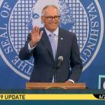 Gov. Jay Inslee waves during his Thursday morning press conference on extending protections for renters. (TVW)