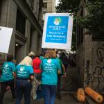 County employees and supporters walk past the King County Courthouse during a march for womens safety at work in Seattle on Friday, Aug. 6, 2021. The march was scheduled after a woman was attacked in a bathroom at the King County Courthouse. Photo by Henry Stewart-Wood/Sound Publishing