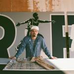Alexander Codd poses in front of the Liberty Park mural (photo by Andrew Valentine)