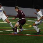 Hazen players surround a Mercer Islander. Andy Nystrom/ staff photo