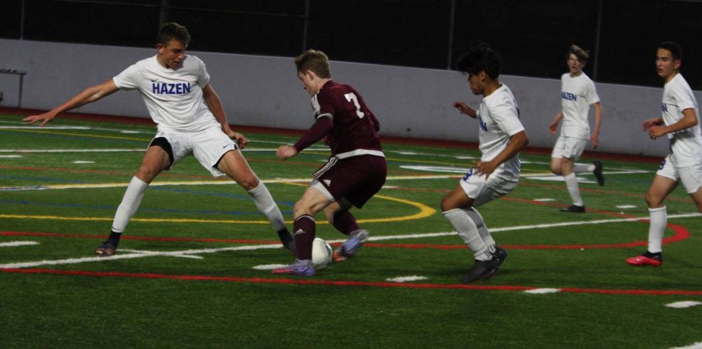 Hazen players surround a Mercer Islander. Andy Nystrom/ staff photo