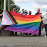 (From left to right) Renton City Councilmember Carmen Rivera, Mayor Armondo Pavone, Councilmember Ryan McIrvin, Councilmember Ed Prince, Police Chief Jon Schuldt and Councilmember Valerie OHalloran hold the Progress Pride flag outside of City Hall. Photo courtesy of the City of Renton.