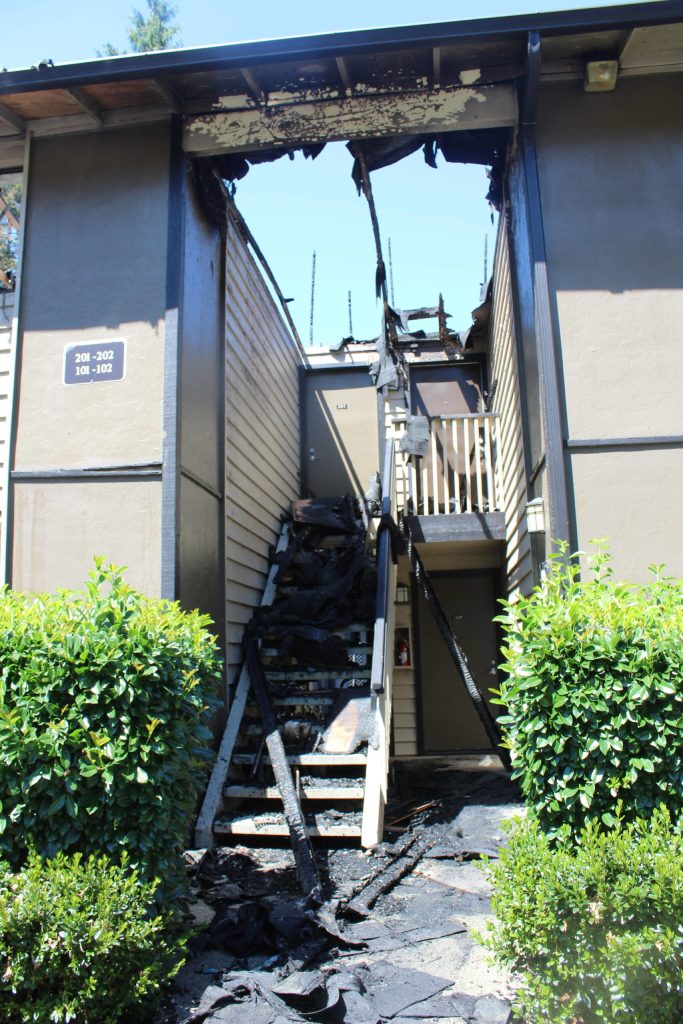 Part of the roof is completely gone in the aftermath of the fire. My apartment is the bottom, on the left. I wasnt home but my husband grabbed our three kids and tried to leave under the arch but it was on fire so they had to go out the opposite side, said Jennifer Daniels of the fire. Photo by Bailey Jo Josie/Sound Publishing.