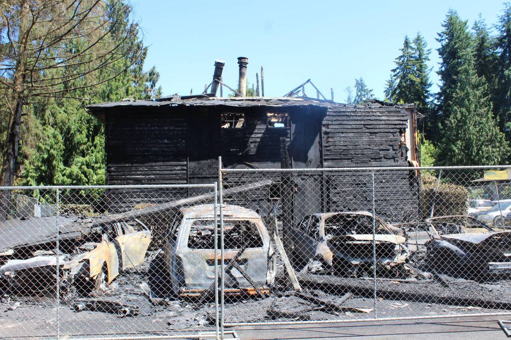 Nearly 24 hours after the fire, several cars, a carport, bushes, and a building reveal severe damage. Firefighters responded to the fire around 6:30 p.m. on Wednesday July 20 and had to return the following morning to put out a rekindled fire. Photo by Bailey Jo Josie/Sound Publishing.