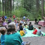 Children, parents, guardians and families gather in the Lake Wilderness Arboretum as Maple Valley librarian Sharon Chastain talks about the trees. Photo by Bailey Jo Josie/Sound Publishing.