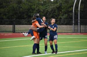 RaeAyn Gilbert leaping into Hailey Younts arms as Lindbergh won the game on penalty shots. Photo by Ben Ray/Renton Reporter