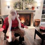 Santa Claus greets guests at the Weatherly Inn lobby. (Cameron Sheppard/Sound Publishing, Inc.)