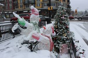 A festive winter display complete with snowmen, presents and a Christmas tree is covered in snow on Dec. 20. Photo by Bailey Jo Josie/Sound Publishing