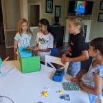 Photo courtesy of Julia Fishler
At the Kids Save The Earth event, Neha shows everyone the model for her litter-gathering robot. From left to right, Milla, Neha, Rohit, Callie and Dinaaz.