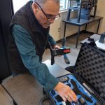Instructor Frank Cantwell prepares to assemble a drone at the GRC Aviation Center.