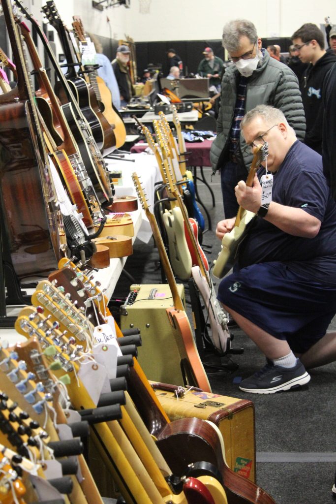 Guests at the guitar show were encouraged to pick up and play with the instruments. Photo by Bailey Jo Josie/Sound Publishing