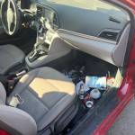 A glass of beer, a joint, a box of unopened condoms and a steering wheel lock on the floor of Doug Lindquists 2019 Hyundai Elantra. (Photo by Ben Leung/Renton Reporter)