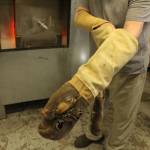 LEFT: Bob Mays puts on kevlar gloves to handle the hot glass hes been working on. 
ABOVE: Bob Mays has been making glass art for decades.
Photos by Bailey Jo Josie/Sound Publishing