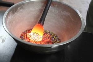 After taking the glass from the furnace, Bob Mays adds dimension and colors before putting the molten glass into the glory hole. Photo by Bailey Jo Josie/Sound Publishing.