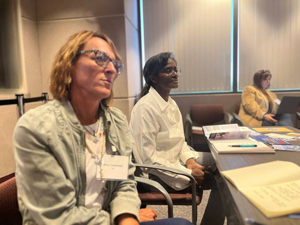 Amy Cresswell (left) of Angels in Sports and Catrenia Fox (right) of the Children's Institute for Learning Differences watch the day's presentations. (Photos by Benjamin Leung/The Reporter)