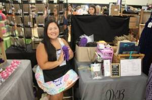 Jessica Bowen crochets while at her Renton River Days vendor stand. (Photo by Annika Hauer/For the Reporter)