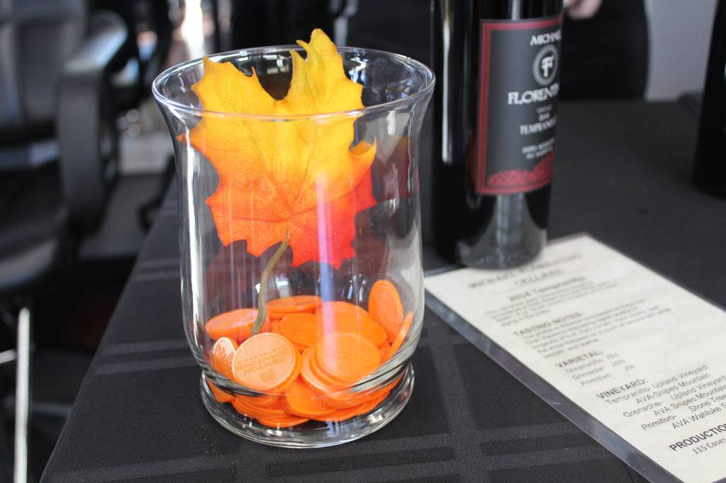 Patrons were given 10 orange Renton Downtown tokens to keep track during the Gobble Wobble Wine Walk. Photo by Bailey Jo Josie/Sound Publishing.