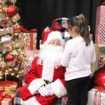 Santa listens intently as one girl tells him what she wants for Christmas. Photo by Bailey Jo Josie/Sound Publishing.