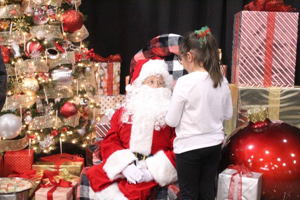 Santa listens intently as one girl tells him what she wants for Christmas. Photo by Bailey Jo Josie/Sound Publishing.