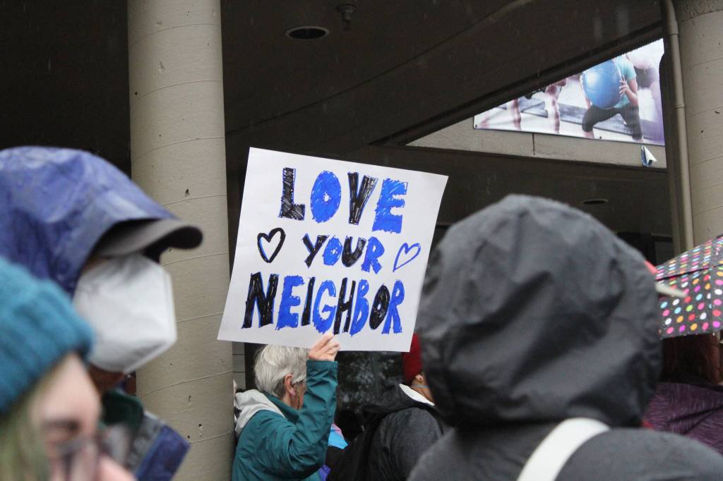 One sign at the counter-protest says, Love your neighbor. Photo by Bailey Jo Josie/Sound Publishing.