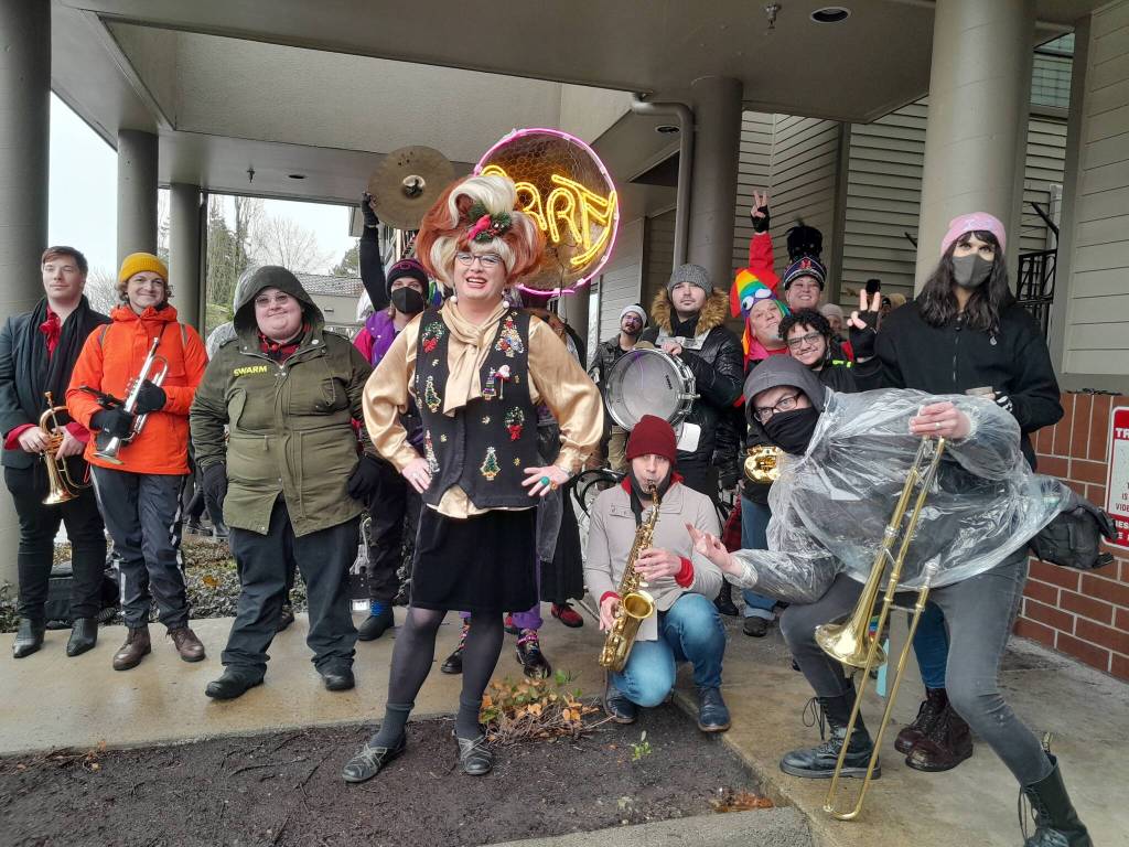Photo by Bailey Jo Josie/Sound Publishing.
Sylvia OStayformore (center, in the Christmas sweater and wig) poses with counter-protesters hours before she reads childrens books for her monthly Drag Queen Story Time.