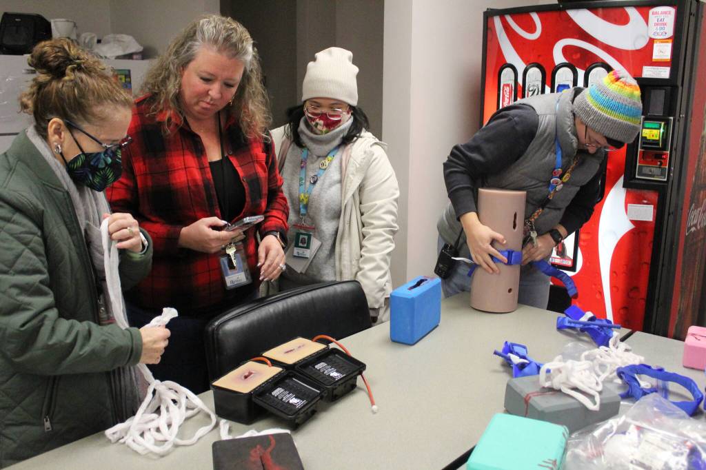 Photo by Bailey Jo Josie/Sound Publishing.
Staff at Bryn Mawr Elementary School practice putting pressure on different wound models.