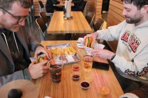 Photo by Bailey Jo Josie/Sound Publishing.
Nigel Quinn and Kyle Martin are about to take their first bites from the first order at Rentons Big Chicken.