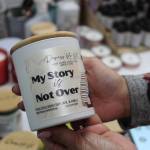 Divina holds a popular candle named, My Story is Not Over. Bailey Jo Josie/Sound Publishing