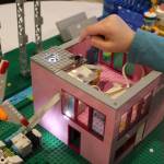 Photo by Bailey Jo Josie/Sound Publishing
Hannah Mattila, 7, shows how solar energy lights the LEGO home she and her team built.