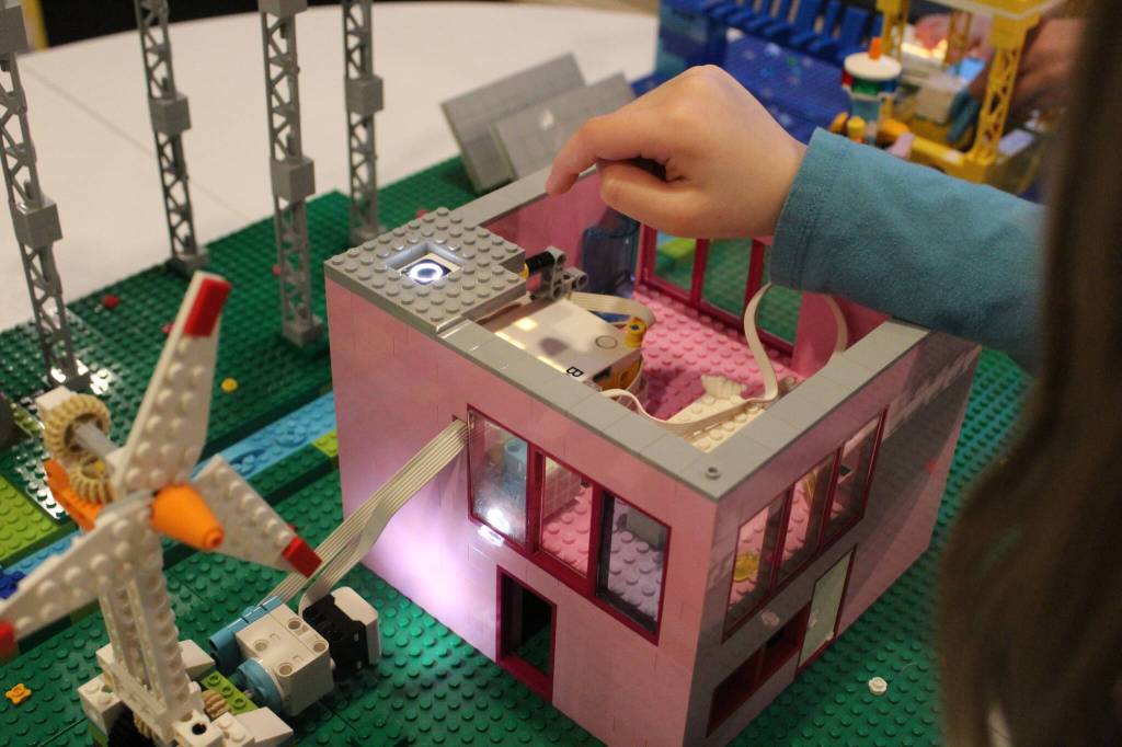 Photo by Bailey Jo Josie/Sound Publishing
Hannah Mattila, 7, shows how solar energy lights the LEGO home she and her team built.