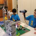 Braxton Fishler, 6, uses a hair dryer to demonstrate wind-powered energy in the teams LEGO project. Photo by Bailey Jo Josie/Sound Publishing.