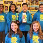 The Rockin Robots pose with their first and final hydro-powered waterspout prototypes, which earned them a second-place trophy. The energy from their project is enough to charge a Kindle, said the team. Photo by Bailey Jo Josie/Sound Publishing.