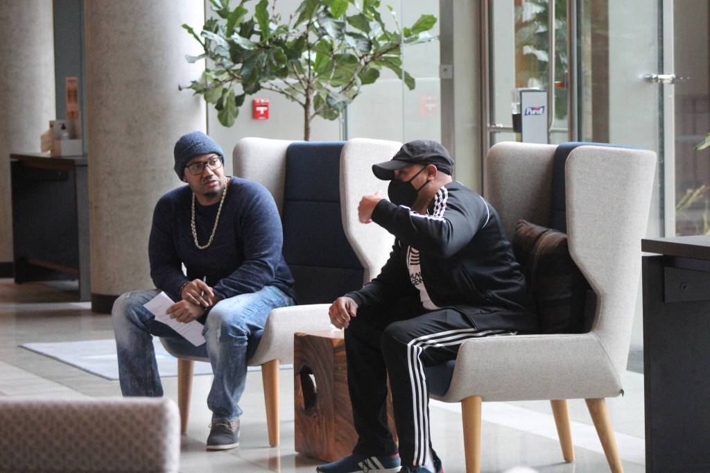 Emcee Charles Conner talks with Dominique Davis of the nonprofit Community Passageways. Photo by Bailey Jo Josie/Sound Publishing.