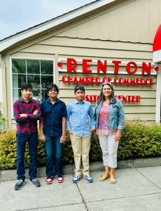 Courtesy photo. Tutum Hospitium founders Krithik, Dhruv and Ashwin stand outside the Renton Chamber of Commerce with Darlene Larsen.
