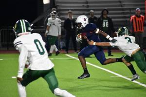 Abdul Gilbert shakes off a defender on his way to the end zone. Ben Ray / The Reporter