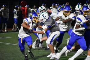 Isaac Rose tries to break a tackle against Liberty. Ben Ray / The Reporter