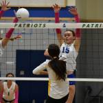 Maiya Lester (9) goes for a block with teammate Julianne Lee (15) against Bellevue. Ben Ray / The Reporter
