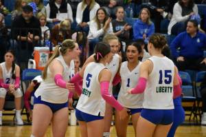 The Liberty team celebrating a point in the first set. Ben Ray / The Reporter