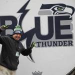 One of the staff who helped lift the drum celebrates being done with the hardest part of the move. (Cameron Sheppard/Sound Publishing)