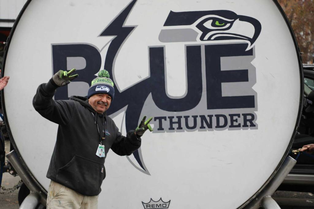 One of the staff who helped lift the drum celebrates being done with the hardest part of the move. (Cameron Sheppard/Sound Publishing)
