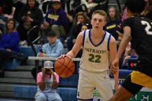 Jackson Whitaker engages with a Bellevue defender. Ben Ray / The Reporter