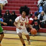 Micah Ili-Meneese (freshman) dribbles down the baseline. Ben Ray / The Reporter