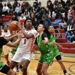 Dennis Johnson, a junior, battles through contact at home against Rancho (Nevada). Ben Ray/The Reporter