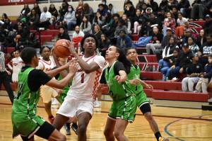 Dennis Johnson, a junior, battles through contact at home against Rancho (Nevada). Ben Ray/The Reporter