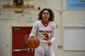 Leilah Spalding take a peek at the scoreboard against Foster. Ben Ray / The Reporter