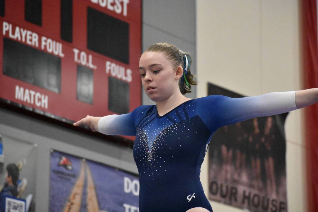 Libertys Maggie Fisher looks down during her beam competition at state. Ben Ray / The Reporter