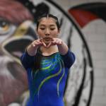 Hazens Aubrey Le focusing in during her balance beam routine. Ben Ray / The Reporter